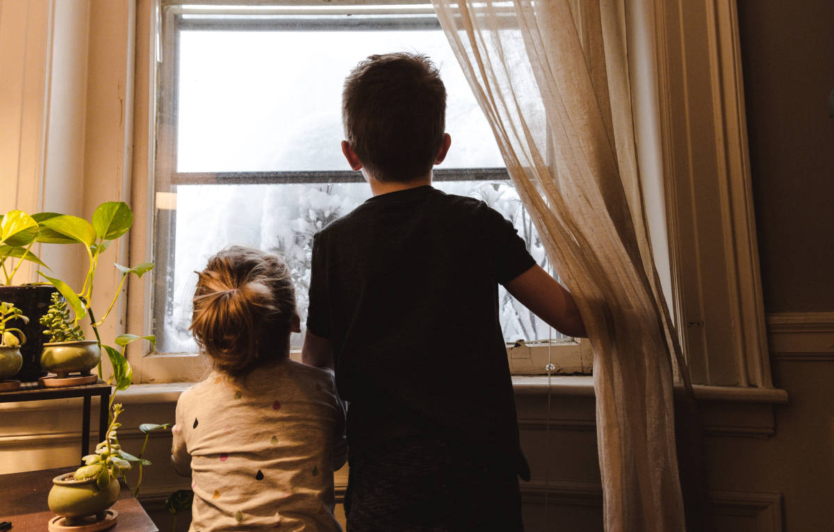 Children looking out window at snow.Voice-Activated Smart Thermostat